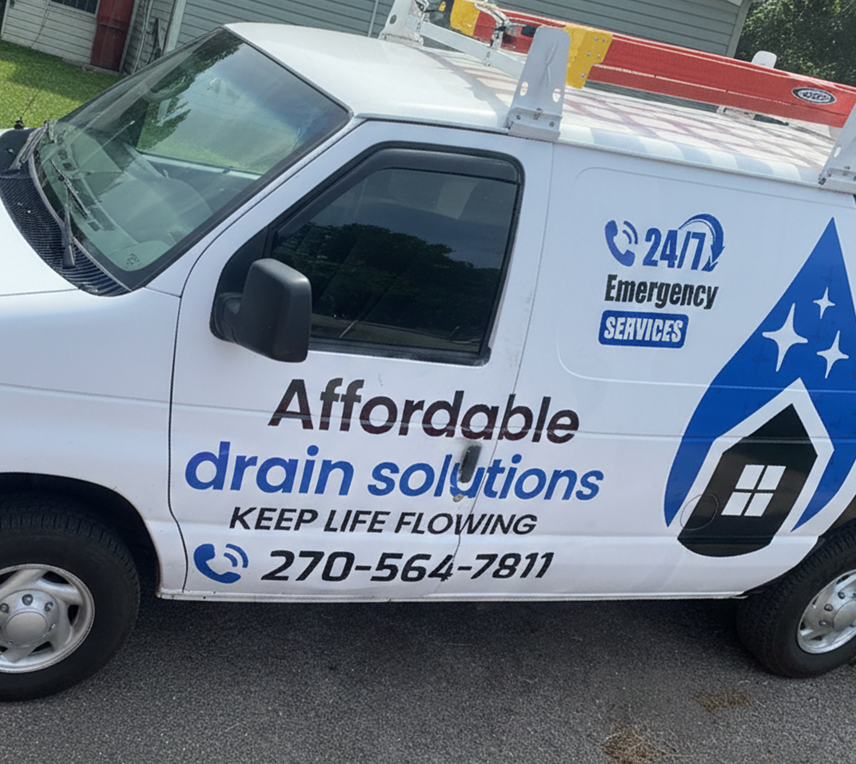Van advertising affordable drain solutions with contact details.
